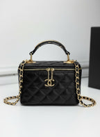 Chanel black quilted synthetic leather vanity crossbody bag with gold chain strap and CC logo.